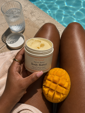 Sea Essence Body Butter held beside a pool
